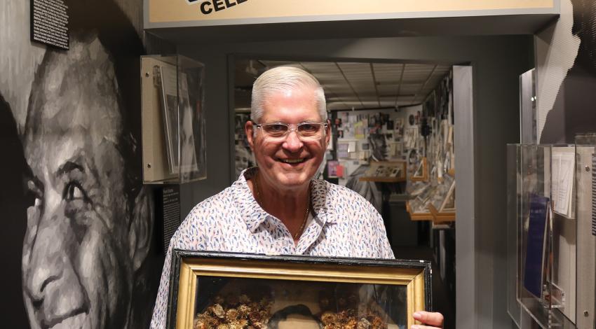 John Herzig holding a memento from Abraham Lincoln's funeral service