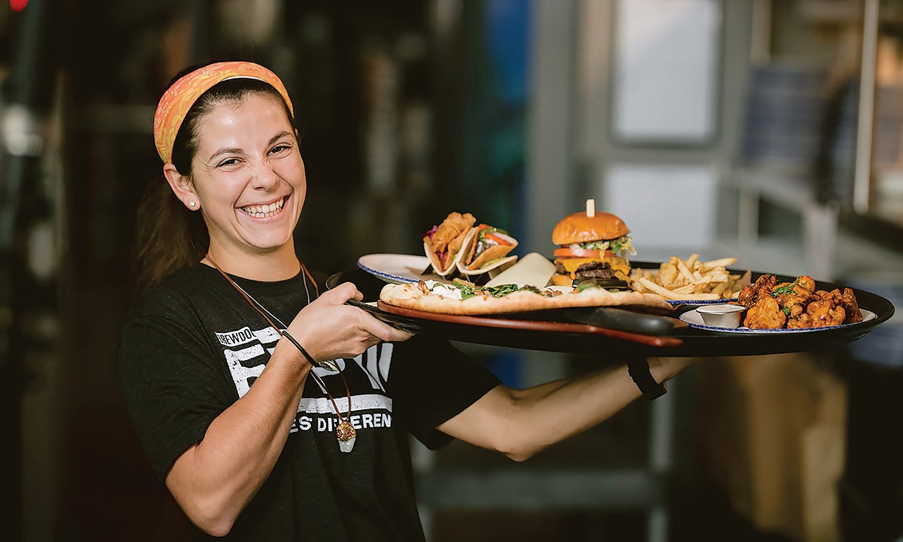 A server at BrewDog's DogHouse serving meals