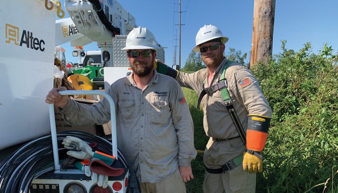 Lineworkers posing by truck