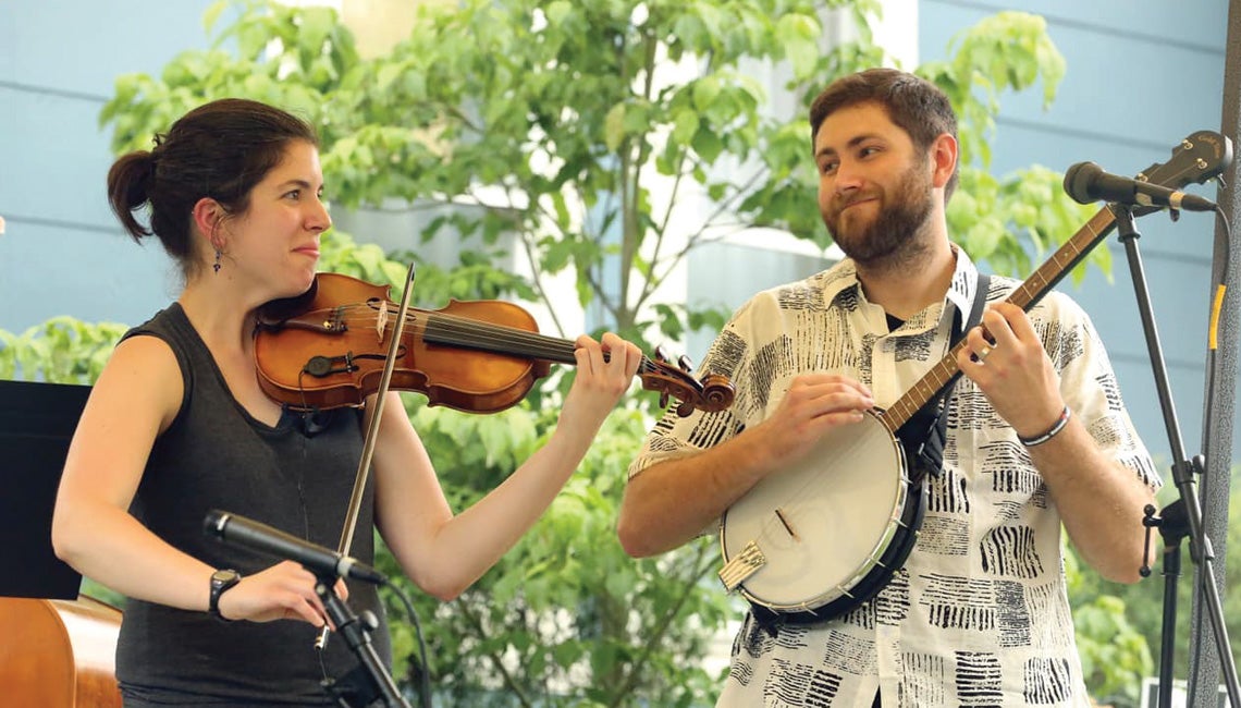 A couple playing banjo and violin