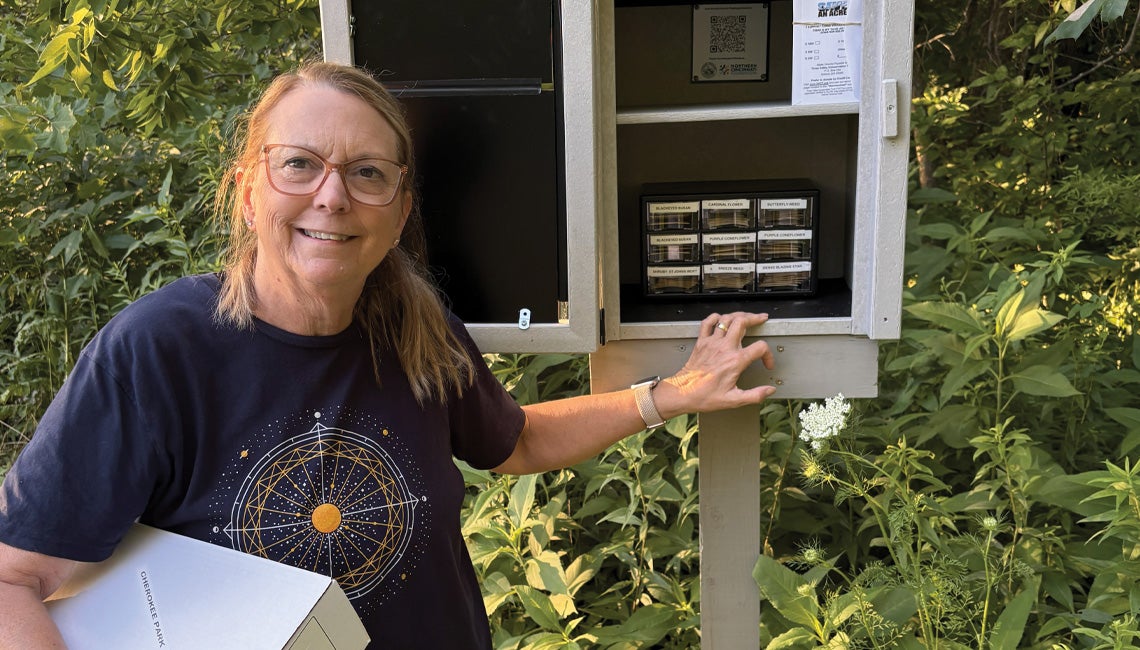 A woman standing with a community seed library