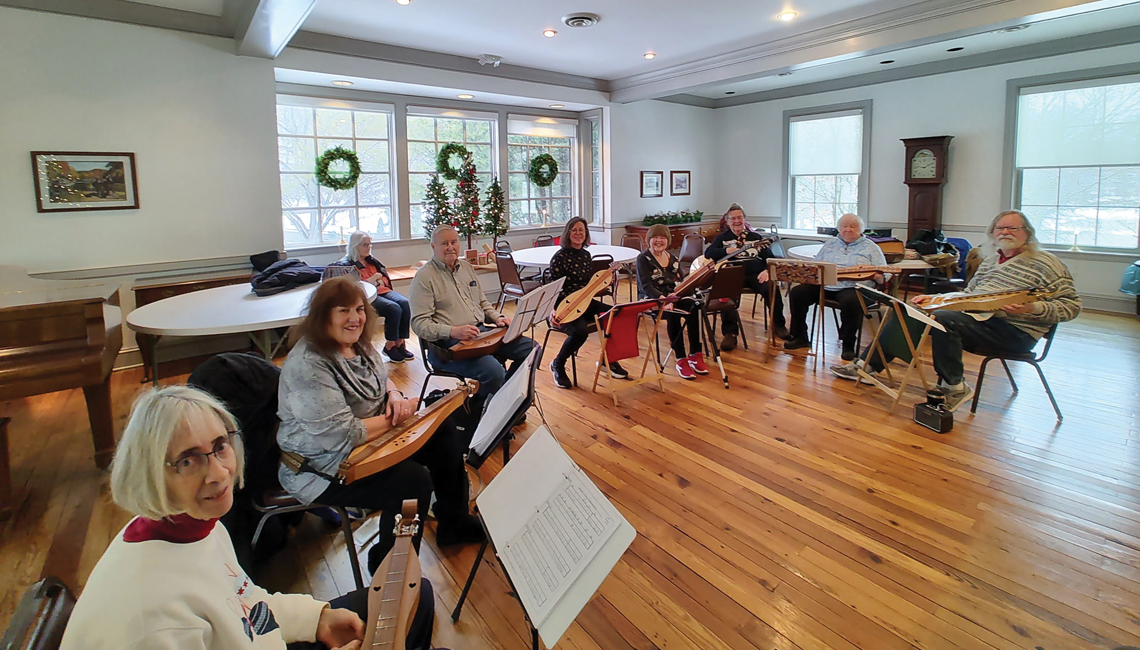 A group of people sitting together with instruments