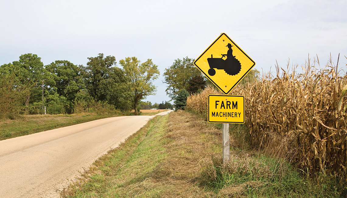 Farm machinery sign on rural road (Credit: Getty Images)