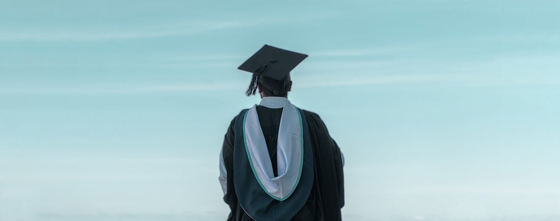 High school graduate in cap and gown