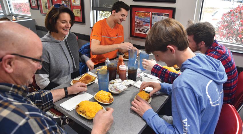 The Weirich family of Cincinnati digs in to a meal at Camp Washington Chili. (Photo by James Proffitt.)