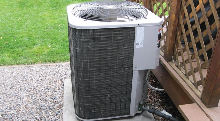 A picture of a heat pump outside of a home.
