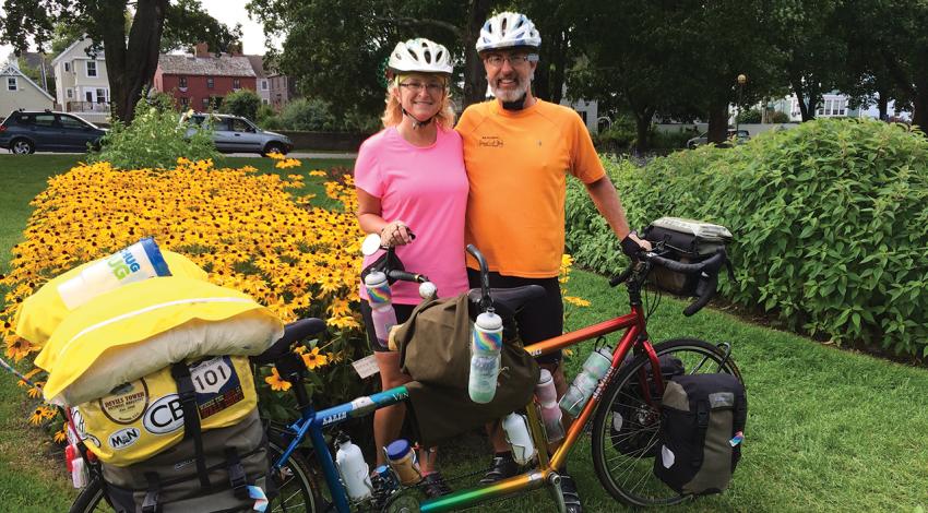 Karen and Bruce Beck pose with their tandem bicycle for a picture.