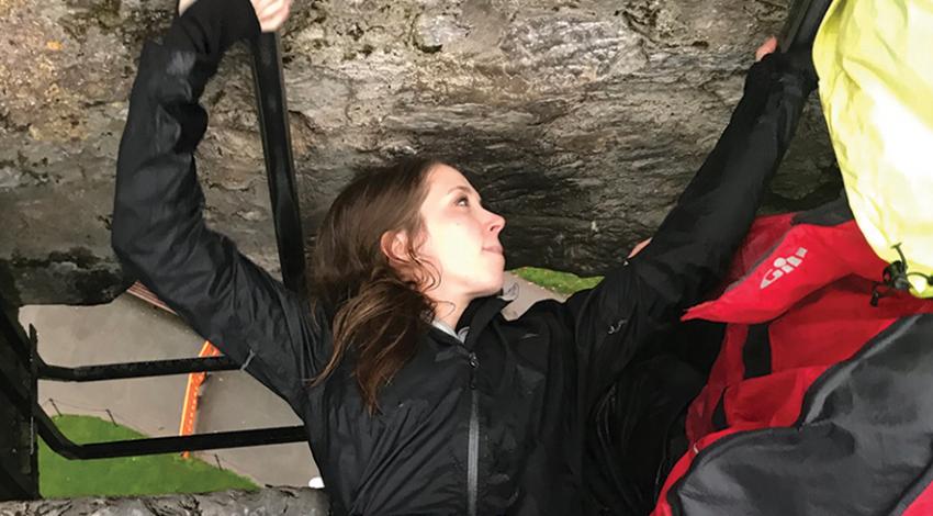 Samantha Kuhn, associate editor of Ohio Cooperative Living, climbs a rock.