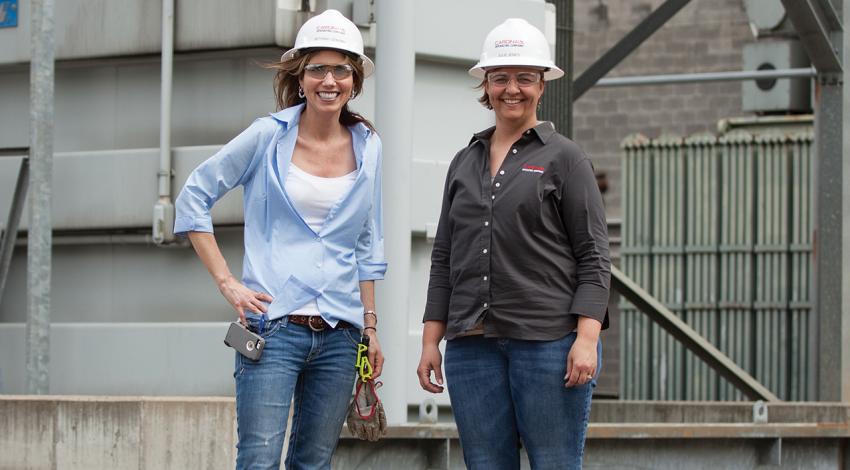 Cardinal Plant Manager Bethany Schunn and Sustainability Lead Julie Jones smile together for a picture.