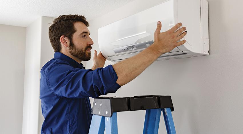 A man installs a blower.