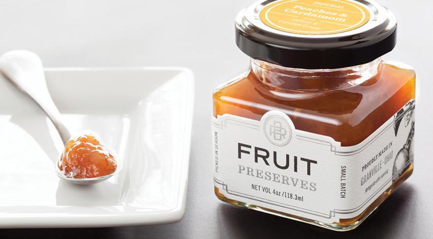 A jar of Black Radish Creamery's fruit preserves next to a plate and spoon.