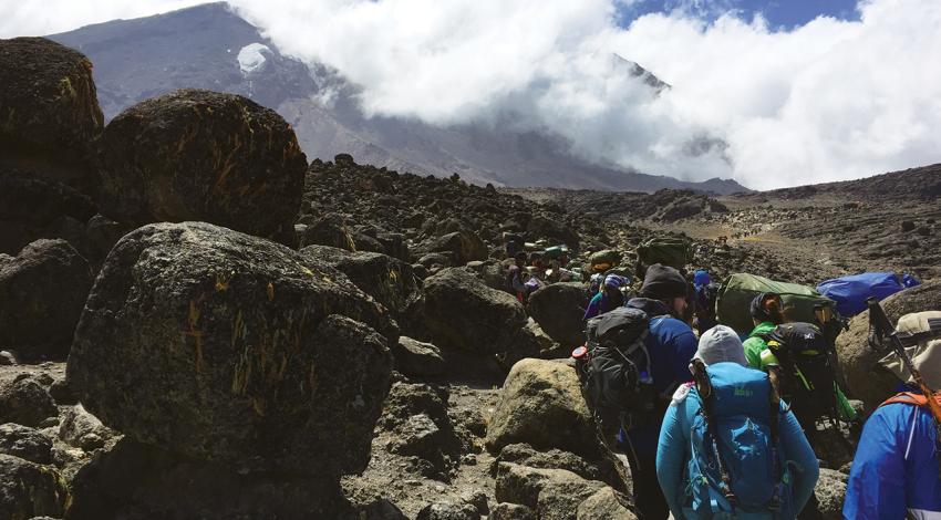 A rocky outcropping with people standing around.