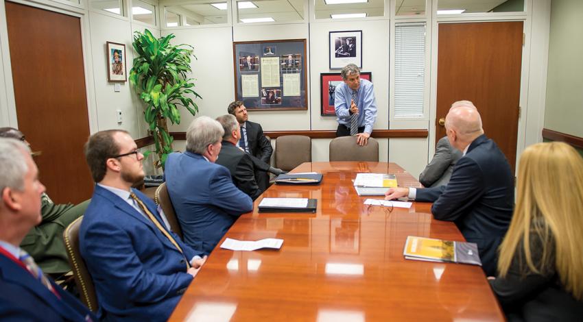 Cooperative leaders sit around a table talking with Senator Sherrod Brown