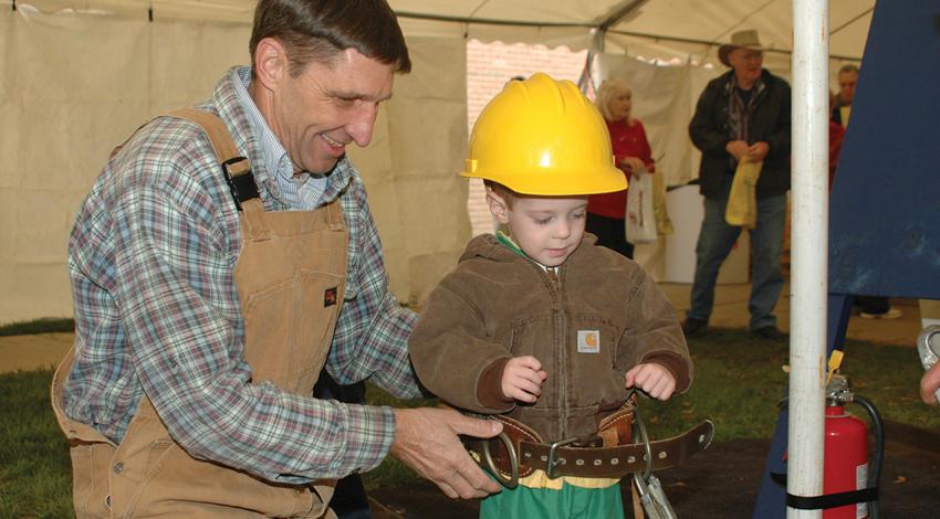 Barry Wisniewski smiles as he gives a safety demonstration to a young attendee.