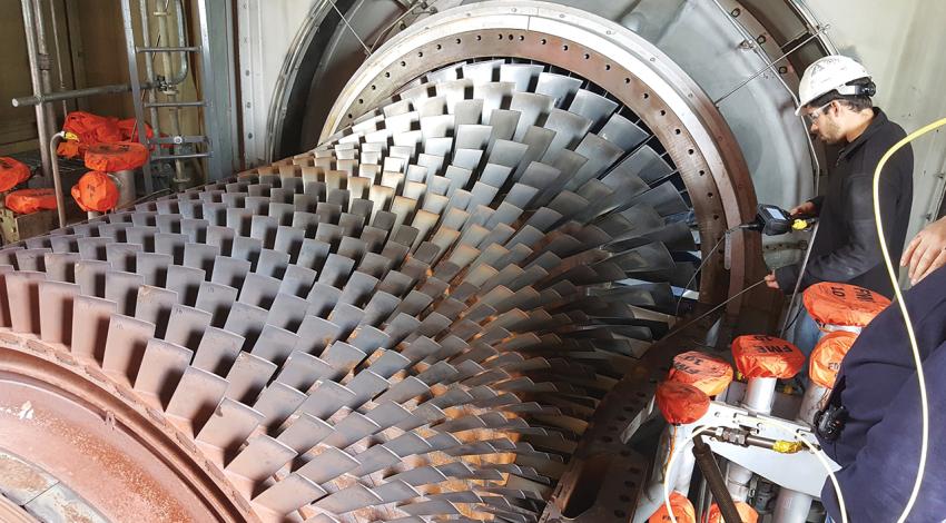 Nick Mascia looks for damage on a turbine.