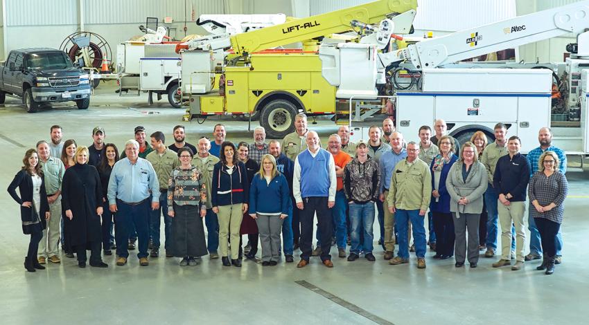 Employees of the cooperative smile for a group picture