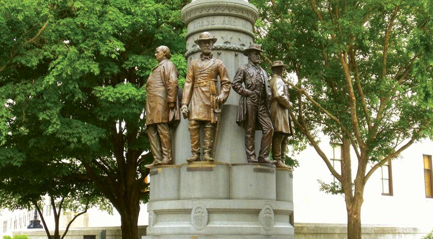 A monument featuring bronze statues of seven Ohioans and a Roman noblewoman.