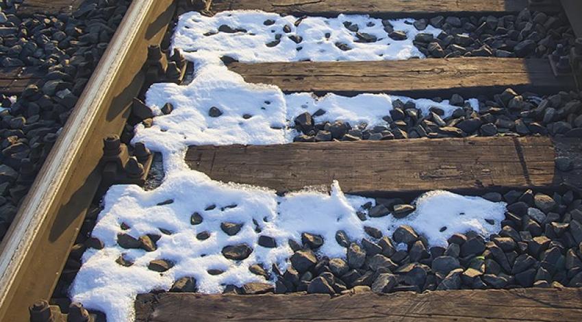 Train tracks covered in snow.