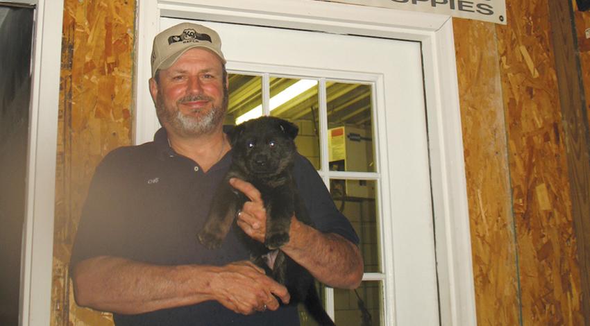 Man holding puppy