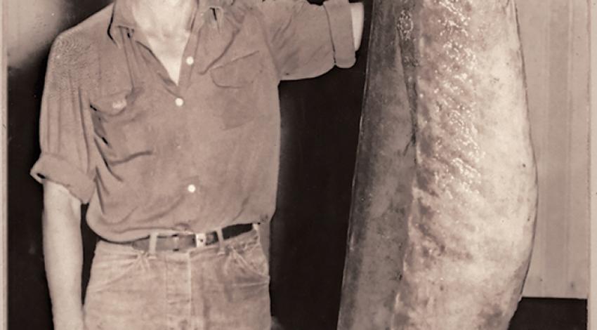 Man with large lake sturgeon