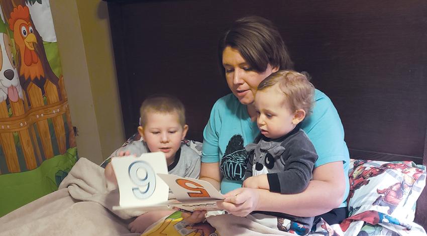 Valerie Williams reads to her children