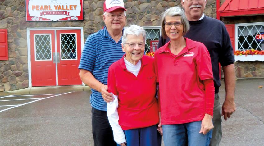 The second and third generations of the Stalder family of cheesemakers: John Stalder and Chuck Ellis stand behind Grace Stalder and Sally 