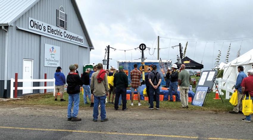 A small crowd gathers next to the Ohio’s Electric Cooperatives Education Building during the Farm Science Review to watch South Central Power Company’s live line safety demonstration.