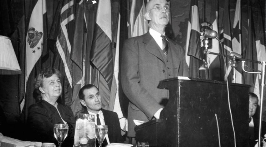 Murray Lincoln addresses an assembly gathered to hear about electrification, as Eleanor Roosevelt (left) listens intently.