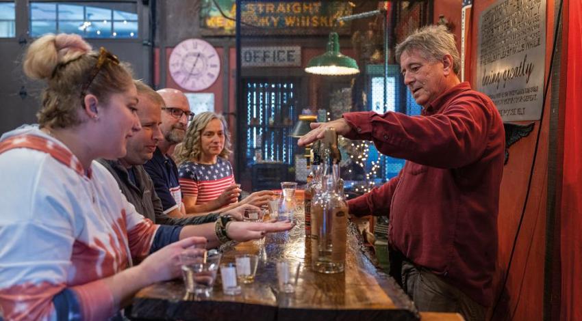 Visitors at Indian Creek Distillery cozy up to the bar for some samples.