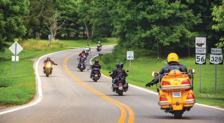 Motorcyclists signaling to each other on the road.