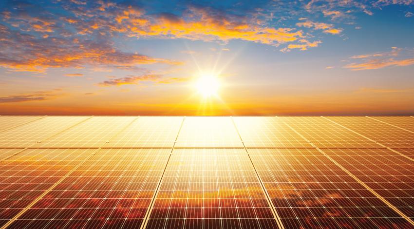 A sunset shining on solar panels