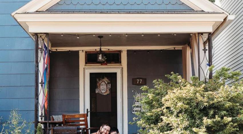 Korey and Abby Wimbiscus Black sitting on their front porch