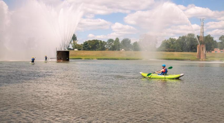 People paddle boarding and kayaking on a river