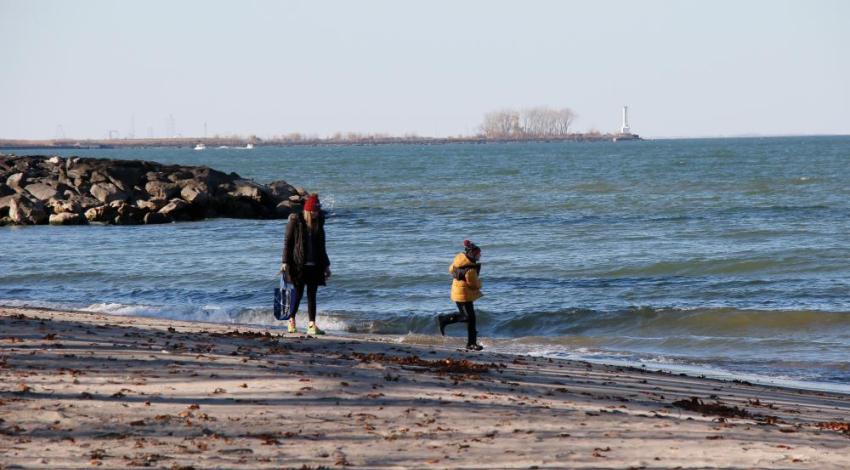 A mother and son walking on a beach
