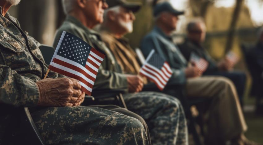 Military service is not always about fighting wars. It’s about growing up. Building confidence. Learning self-discipline. It’s about being part of something bigger than yourself. Veterans sitting with American flags