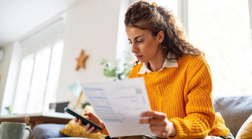 Woman looking at bills