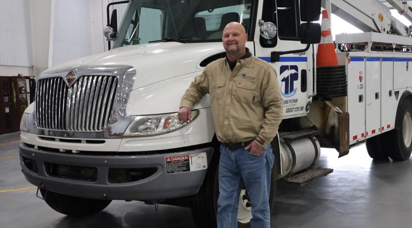 lineworker in front of truck