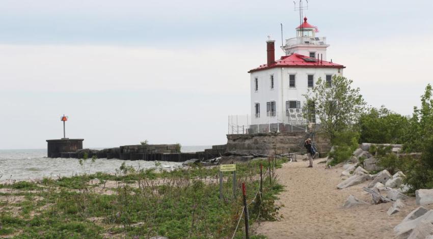 A person standing in front of a lighthouse