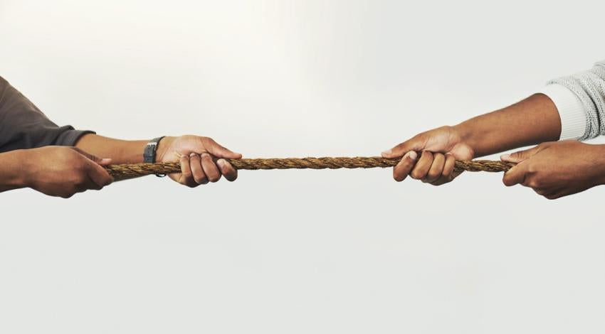 Two people pulling on a rope