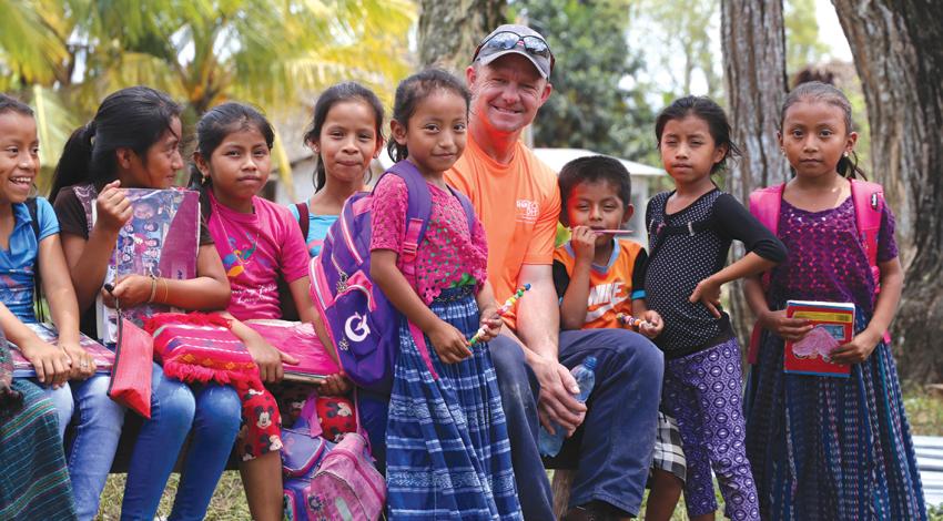 Lineworker with Guatemalan children