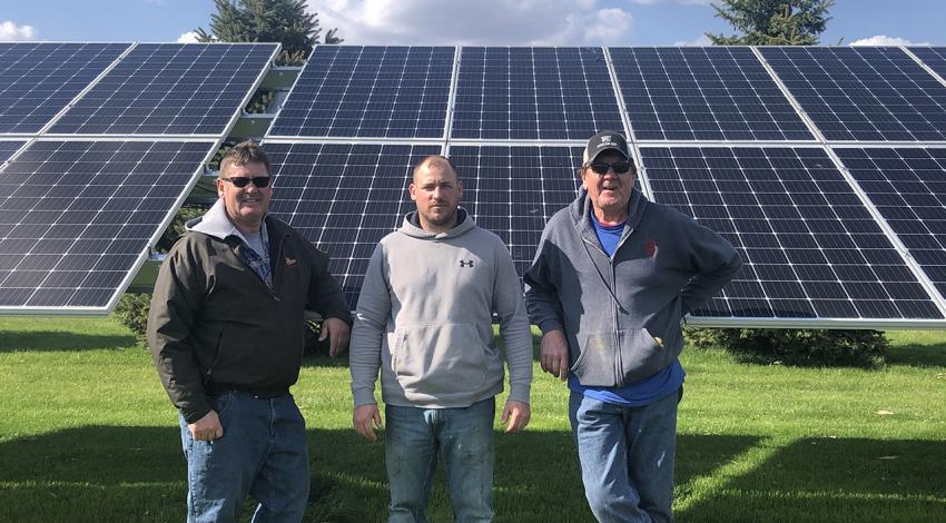 Tietje family in front of solar panels