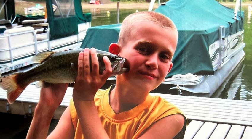 boy holding a fish
