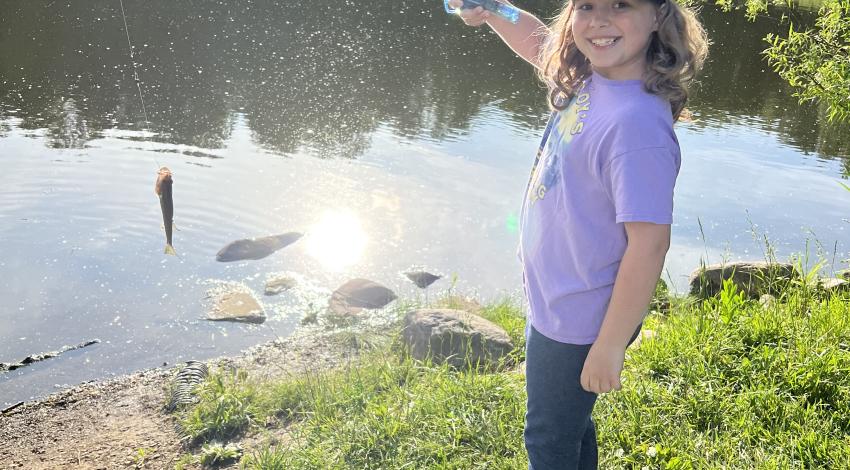 girl smiling holding fish