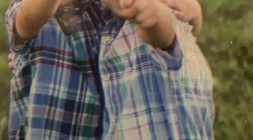 two little boys next to each other, pointing forward