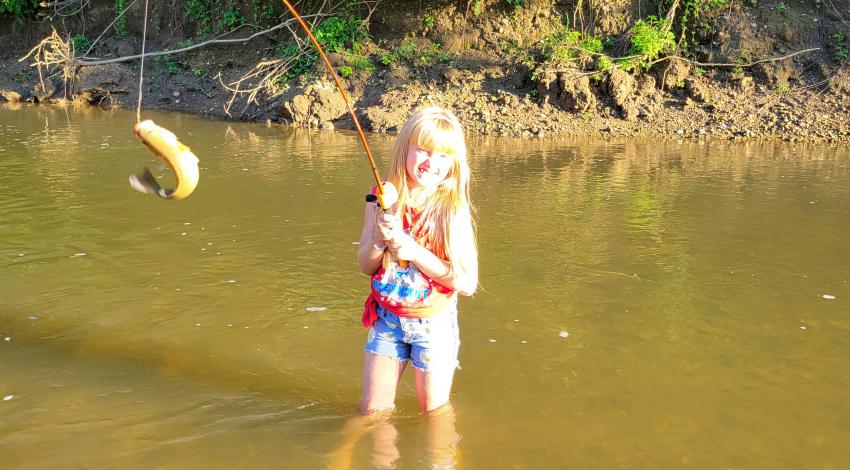 girl smiling holding fish