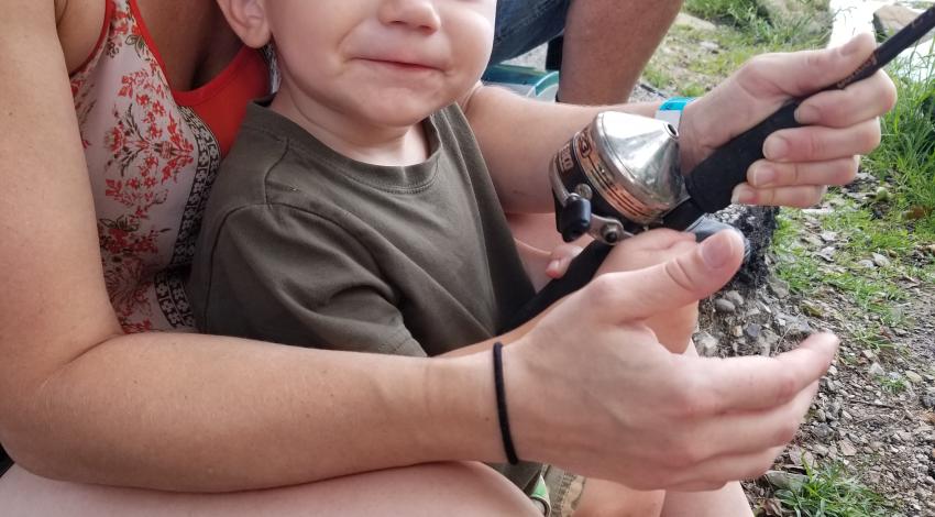 Little boy smiling while fishing