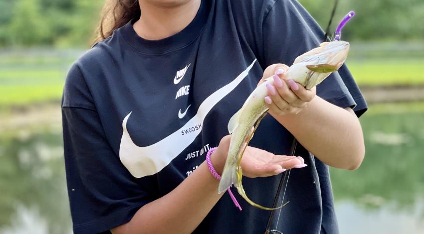 girl smiling holding fish