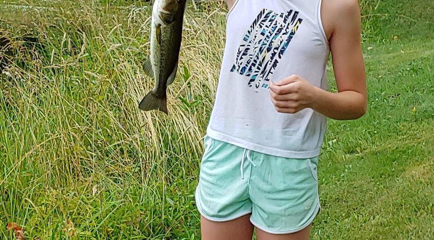 girl smiling holding fish