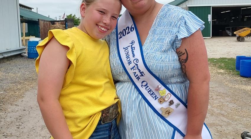 two girls, one with crown and sash