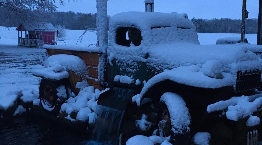 old-fashioned pickup truck covered in snow